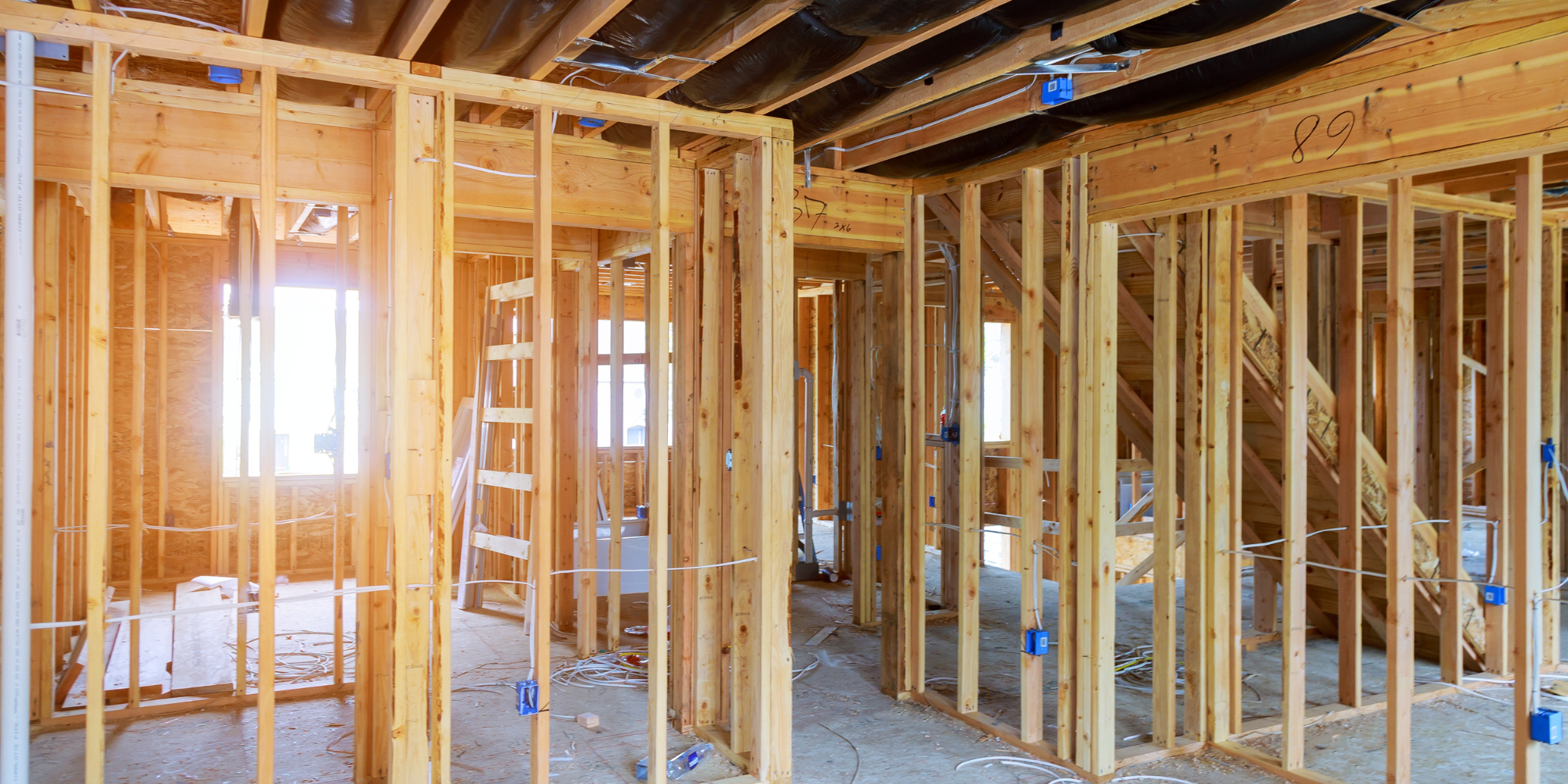 A house under construction with wooden framing