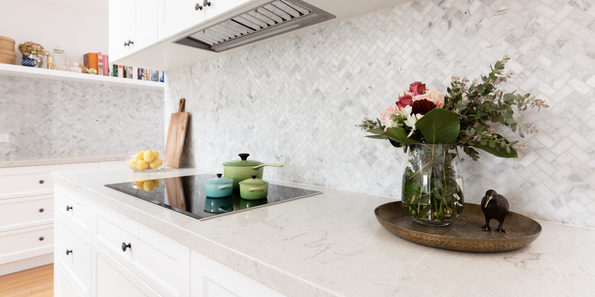 A vase of flowers sitting on a kitchen counter